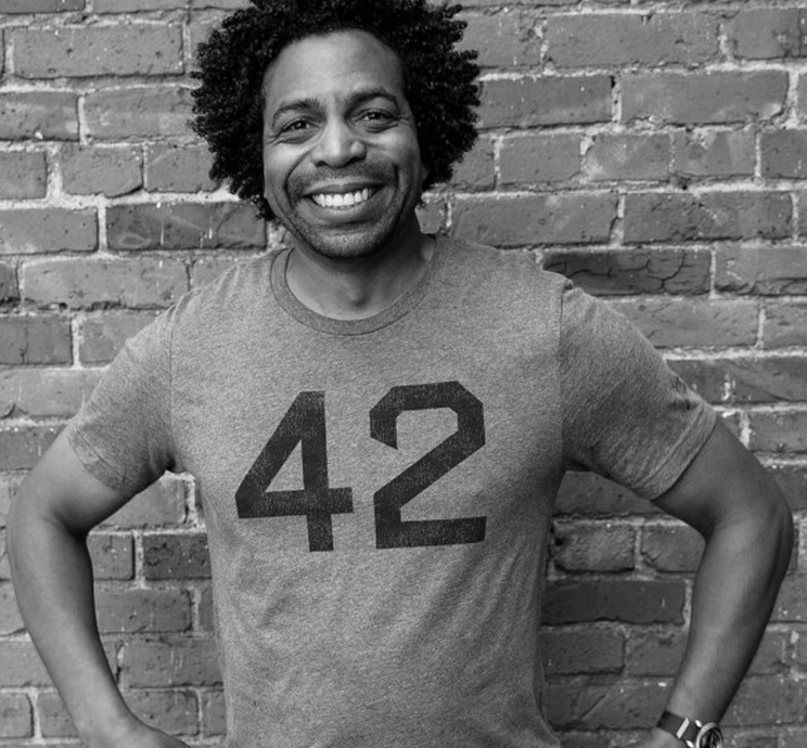Black and white photo of man wearing 42 t-shirt